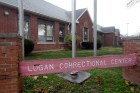 A sign reading Logan Correctional Center in front of a one-story brick building