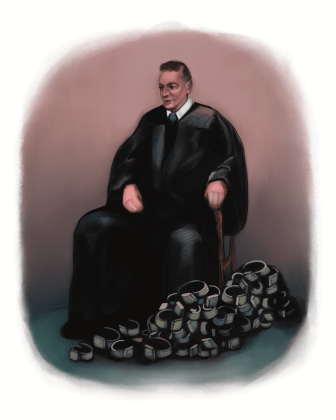A judge in a Black robe with a pile of SCRAM bracelets at his feet