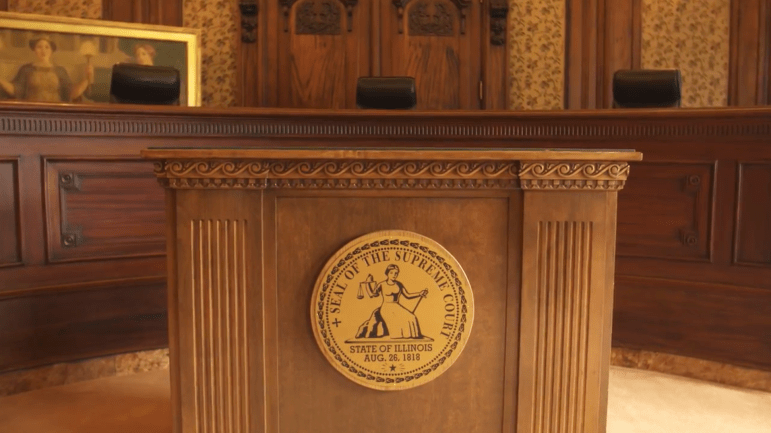 Empty courtroom with the seal of the Illinois SUpreme Court