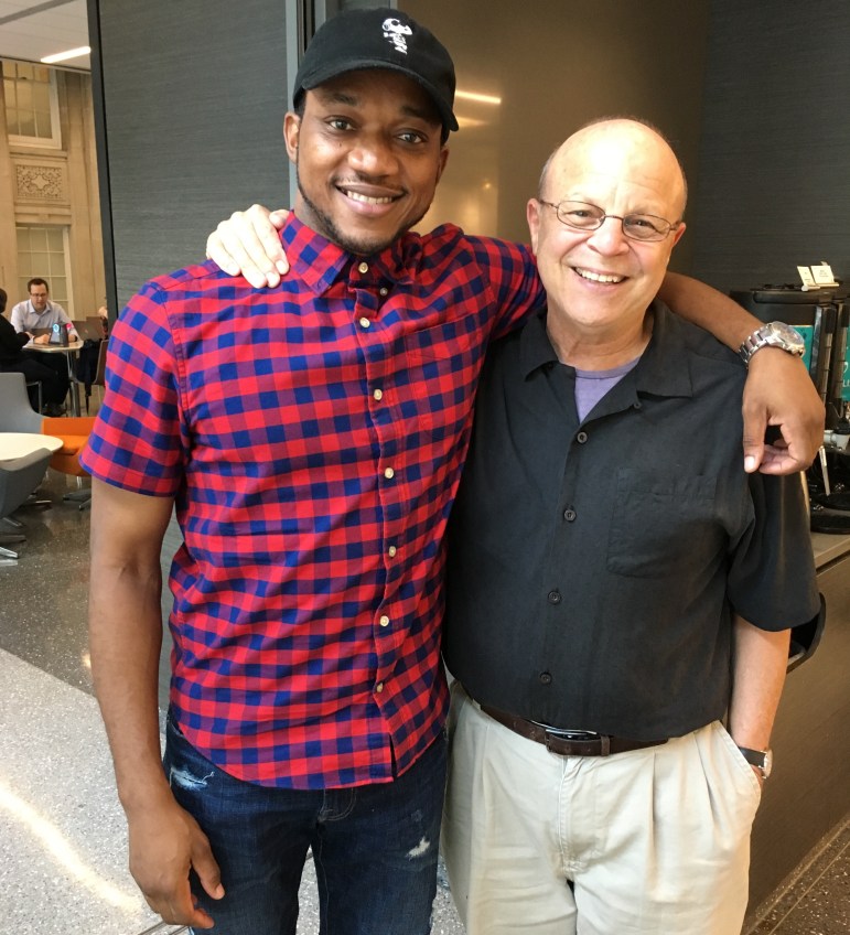 Olutosin Oduwole (left) and attorney Jeffrey Urdangen pose for a picture at the Northwestern University Pritzker School of Law.